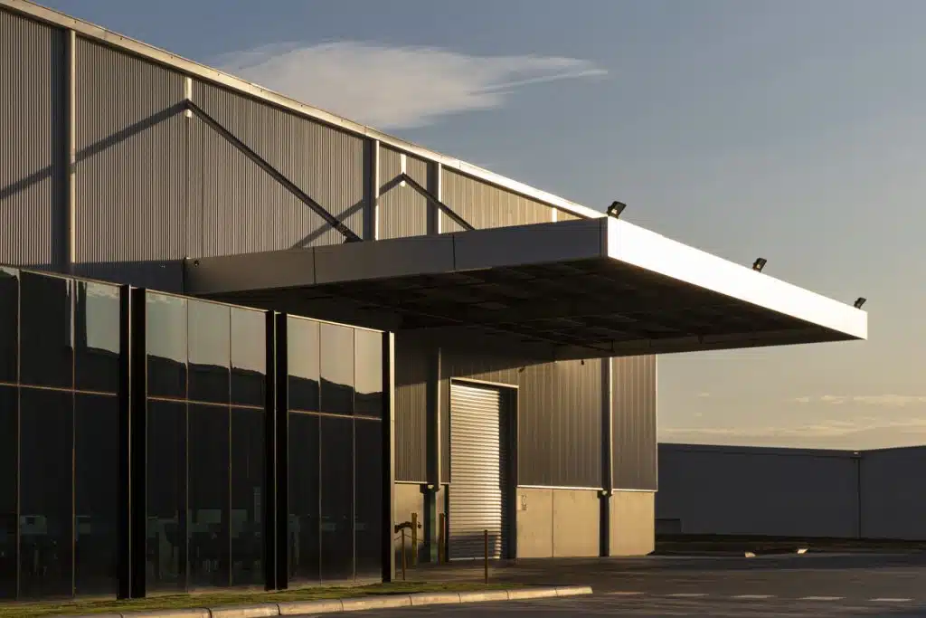 Industrial office & warehouse architecture bathed in afternoon light.